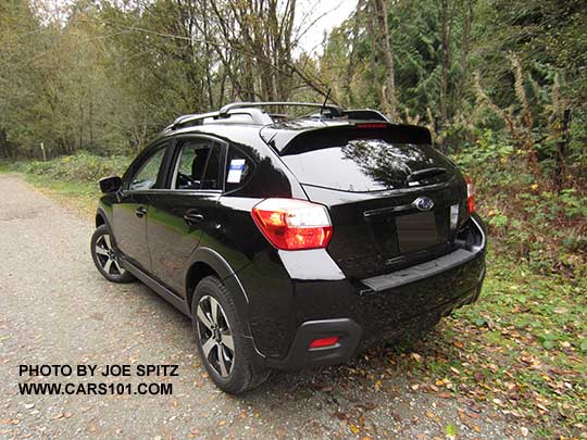 2017 Subaru Crosstrek Premium Special Edition showing rear spoiler's black rear edge and black logos . Crystal black car shown