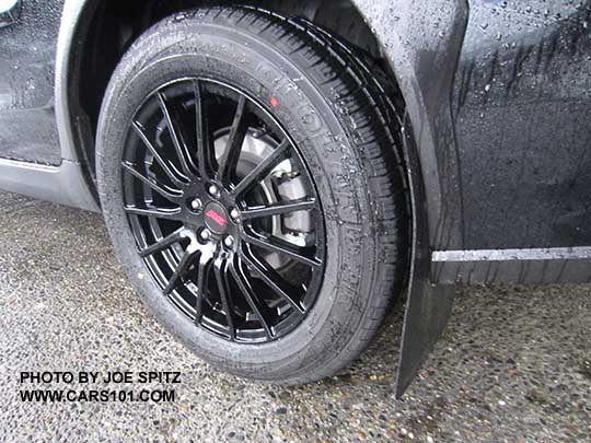 2017 Subaru Crosstrek with optional black STI alloys and aftermarket Rally Armor mud flaps, shown in the rain