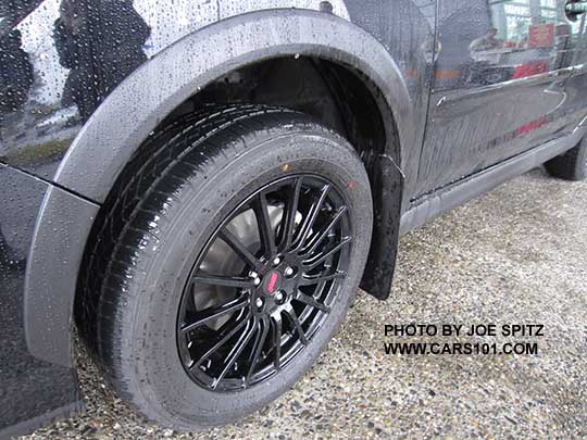 2017 Subaru Crosstrek with optional black STI alloys and aftermarket Rally Armor mud flaps, shown in the rain