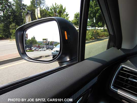 2018 Subaru Crosstrek's yellow blind spot detection symbol displays in the outside mirror housing. Driver's side shown