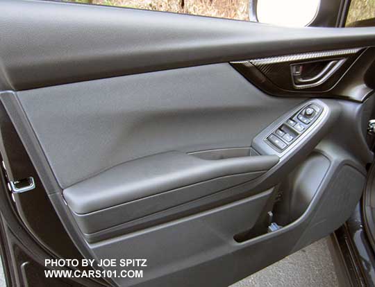 2018 Subaru Crosstrek driver's door panel, 2.0i and Premium black cloth insert, black door handle, matte carbon fiber patterned plastic trim, black tipped power window switches