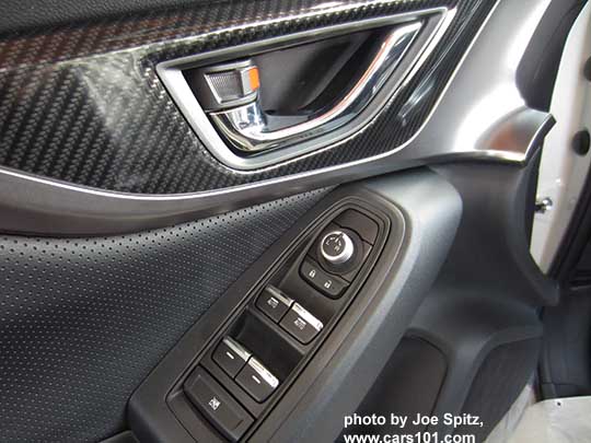 2018 Subaru Crosstrek driver's door panel, Premium black cloth insert, black door handle, matte carbon fiber patterned plastic trim, black tipped power window switches