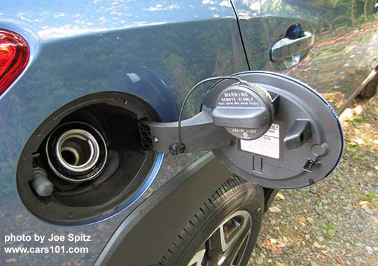 2018 Subaru Crosstrek gas door on passenger side, with both cap tether and door cap holder.