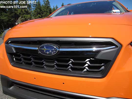 2018 Subaru Crosstrek front grill. Limited shown with chrome bright top half of the center accent bar, and gloss black lower half, with center logo.
