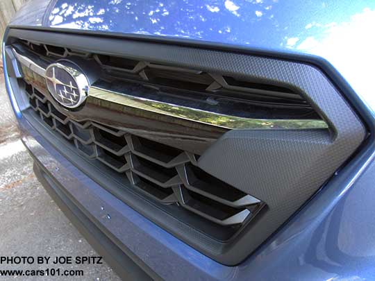 2018 Subaru Crosstrek front grill. Limited shown with chrome bright top half of the center accent bar, and gloss black lower half, with center logo