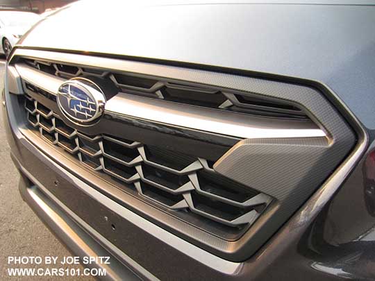 2018 Subaru Crosstrek front grill. 2.0i and Premium model grill shown with satin top half of the center accent bar, and gloss black lower half, with center logo.