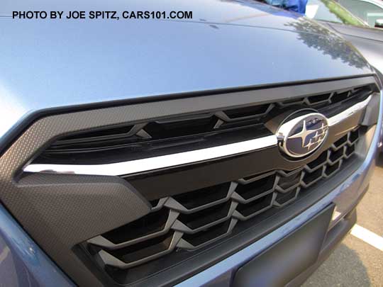 2018 Subaru Crosstrek front grill. Limited model shown with chrome bright top half of the center accent bar, and gloss black lower half, with center logo