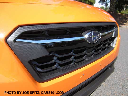 2018 Subaru Crosstrek front grill. Limited model shown with chrome bright top half of the center accent bar, and gloss black lower half, with center logo. (2.0i and Premium models have a satin upper half)