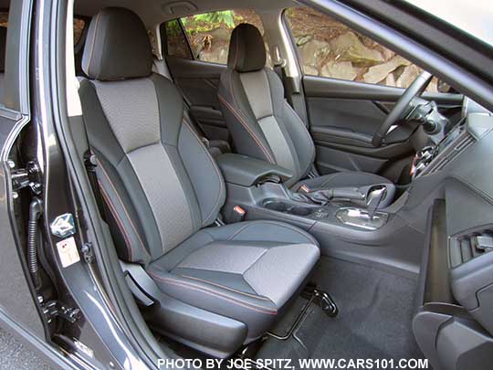 2018 Subaru Crosstrek Premium CVT, silver shift plate, dark carbon fiber-like dash trim, black cloth seats with orange stitching.