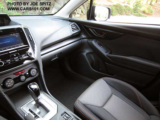 2018 Subaru Crosstrek Premium CVT, silver shift plate with gloss black shift knob, 6.5" audio screen, dark carbon fiber-like dash trim, black cloth seats with orange stitching.-