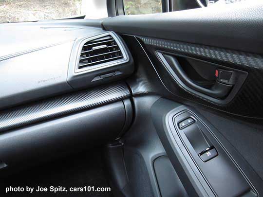2018 Subaru Crosstrek Premium passenger dash and door corner has dark carbon fiber-like trim and matte inside door handle,