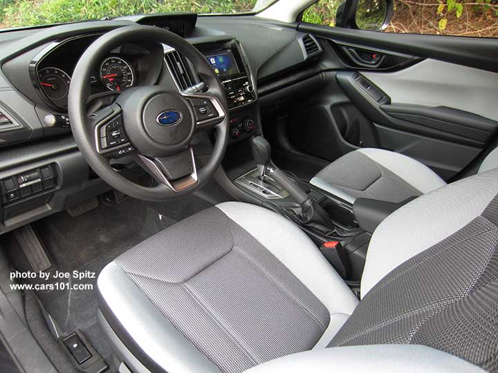 2018 Subaru Crosstrek 2.0i CVT base model, light and dark gray cloth with black stitching, vinyl covered steering wheel, silver shift plate, vinyl shift knob.