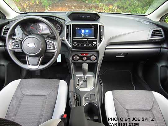 2018 Subaru Crosstrek 2.0i CVT base model, light and dark gray cloth with black stitching, vinyl covered steering wheel, silver shift plate, vinyl shift knob