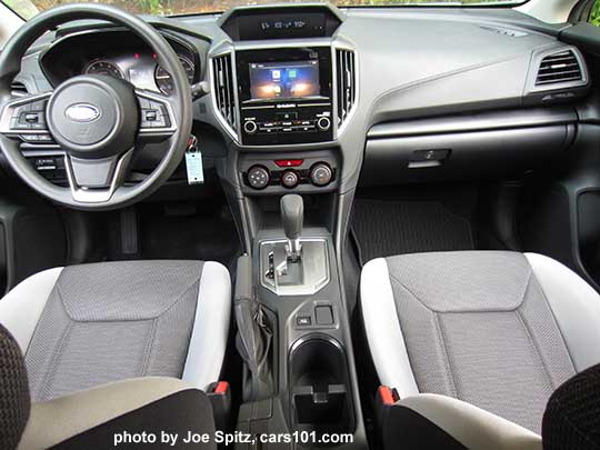 2018 Subaru Crosstrek 2.0i CVT, base model, vinyl covered steering wheel,  silver shift plate, vinyl shift knob, 6.5" audio screen,  light and dark gray cloth with black stitching, No heated seat buttons on the center console.