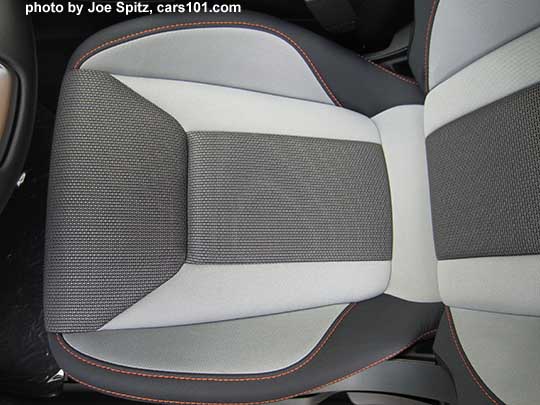 closeup of the 2018 Subaru Crosstrek Premium light and dark gray cloth with orange stitching. Driver's seat cushion shown. Note- in some photos the light gray may appear almost white, its really a light pewter gray