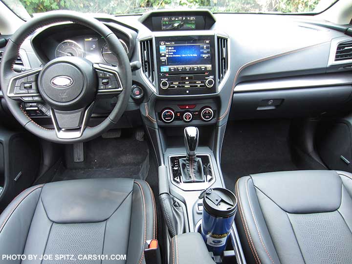 2018 Subaru Crosstrek Limited with perforated black leather with orange stitching, gloss black shift trim, 8" audio screen, climate control knobs, silver dash trim.