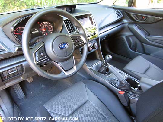 2018 Subaru Crosstrek 2.0i (base model) interior with manual 6speed transmission, gray cloth, black stitching, vinyl covered steering wheel, no heated seat buttons.