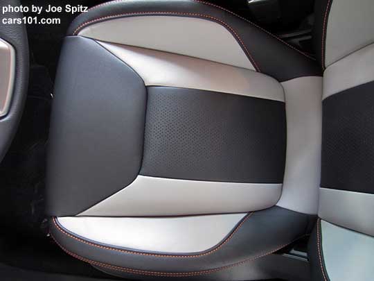 2018 Subaru Crosstrek Limited perforated gray leather seating surfaces with orange stitching and matching leatherette. Its light gray bolsters with dark gray seating area. Driver's seat cushion and lower back shown.  Note- in some photos the light gray may appear almost white, its really a light pewter gray