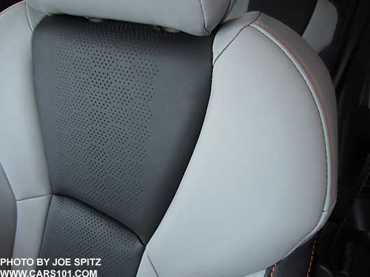 closeup of the 2018 Subaru Crosstrek Limited perforated gray leather seating surfaces with orange stitching and matching leatherette. Its light gray bolsters with dark gray seating area. Upper driver's seatback and headrest shown.  Note- in some photos the light gray may appear almost white, its really a light pewter gray