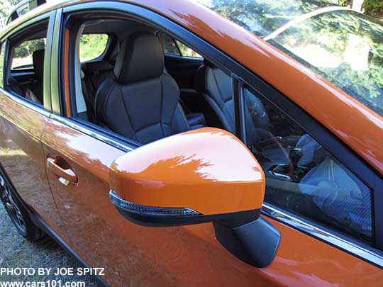 2018 Subaru Crosstrek Limited body colored outside mirror with integrated LED turn signals. On a sunshine orange car. with black leather