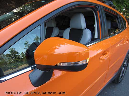2018 Subaru Crosstrek Limited with bright window trim. and body colored outside mirror with integrated LED turn signals. On a sunshine orange car. with gray perforated leather and optional body side moldings