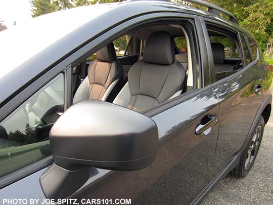 2018 Subaru Crosstrek 2.0i unpainted matte black outside mirror, rubber lower window trim, on a dark gray car