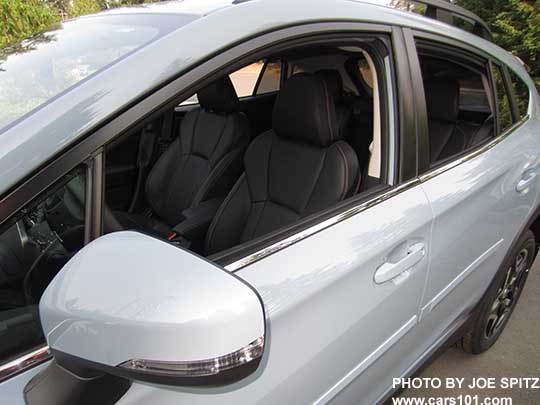 2018 Subaru Crosstrek Limited with bright window trim and body colored outside mirrors with LED turn signals. Cool gray khaki car with black leather interior shown.