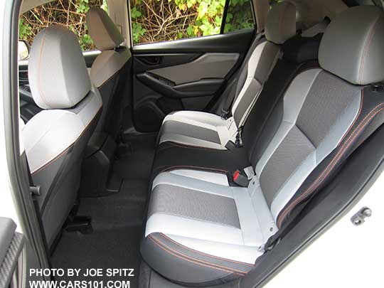 2018 Subaru Crosstrek Premium rear seat. Gray cloth interior with orange stitching. Note the light gray is actually darker than it appears in this photo