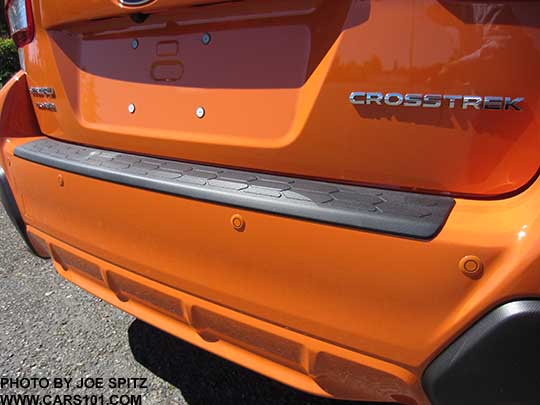 2018 Subaru Crosstrek optional rear bumper cover, and Reverse Auto Brake sensors. Sunshine orange shown.