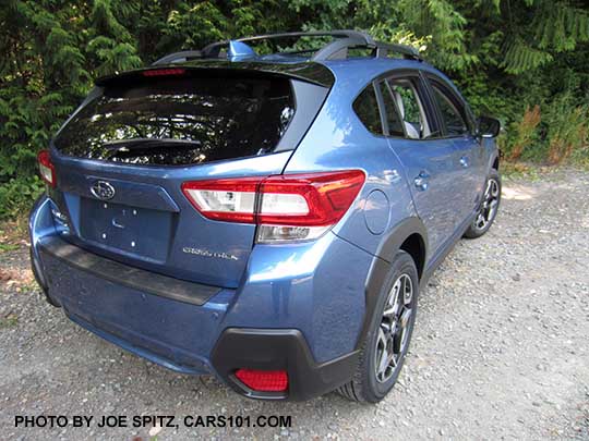 2018 Subaru Crosstrek Limited (Limited wheels). Quartz Blue color shown with standard gloss black rear spoiler