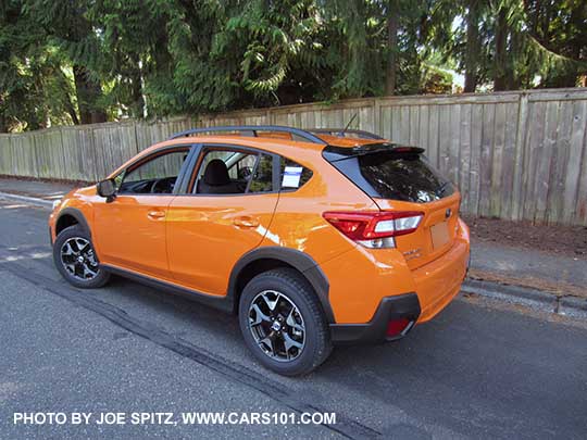 2018 Subaru Crosstrek 2.0i base model with unpainted black outside mirrors. Sunshine orange shown.