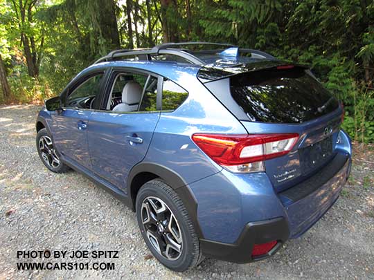 2018 Subaru Crosstrek Limited (Limited wheels). Quartz Blue color shown with standard gloss black rear spoiler
