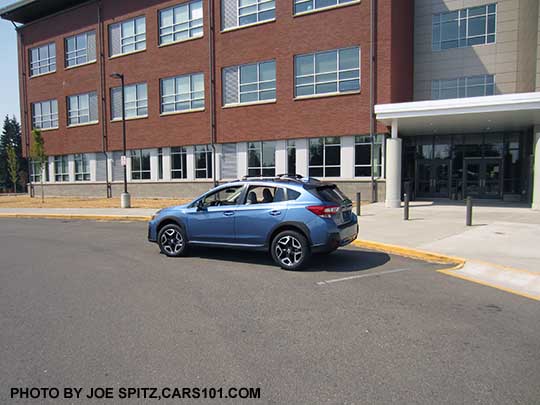 2018 Subaru Crosstrek Limited (Limited wheels). Quartz Blue color shown with standard gloss black rear spoiler