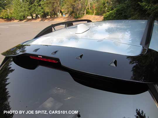 2018 Subaru Crosstrek optional gloss black STI rear spoiler with vortex generator fins, shown on a cool gray khaki car