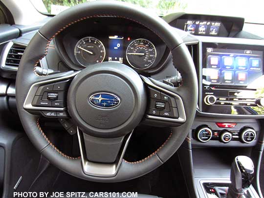 2018 Subaru Crosstrek Limited leather wrapped steering wheel with orange stitching, and optional Eyesight controls (see right side). limited's have the 8" audio, and gloss black shift plate