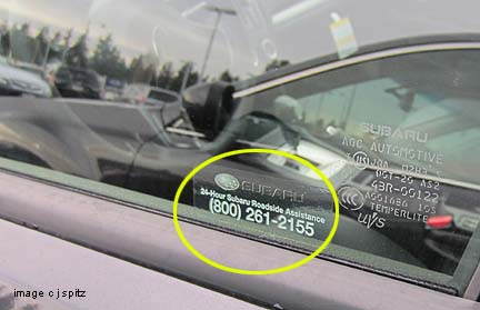 Subaru roadside assistance phone number is on the drivers window