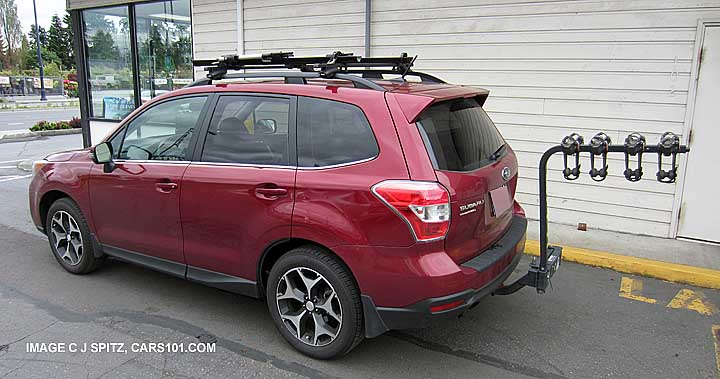 subaru forester with aftermarket hitch mounted 4 bike carrier and crossbars