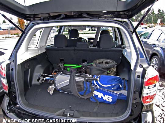 2015 and 2014 subaru forester 2.5i with golf clubs and hand cart in the cargo area