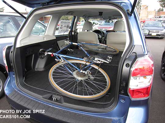 2015 and 2014 Subaru Forester with
                    a bike in the cargo area