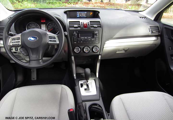 2015 Subaru Forester 2.5i interior with vinyl wrapped steering wheel, light gray cloth interior
