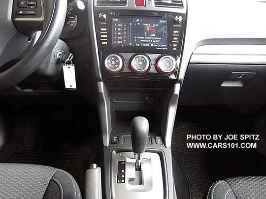 2016 Subaru Forester Premium CVT interior. Black cloth, silver shift surround, vinyl wrapped steering wheel, 7" audio screen 2016 Subaru Forester Premium CVT console- 7 inch audio screen, silver shift surround, black cloth seating