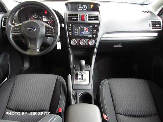 2016 Subaru Forester Premium CVT interior. Black cloth, silver shift surround, vinyl wrapped steering wheel, 7" audio screen