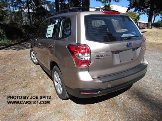 2016 Forester rear view, Burnished bronze 2.5i base model (no dark tinted windows) shown with Option Package #02 alloy wheels/roof rails/auto up-down driver's window,