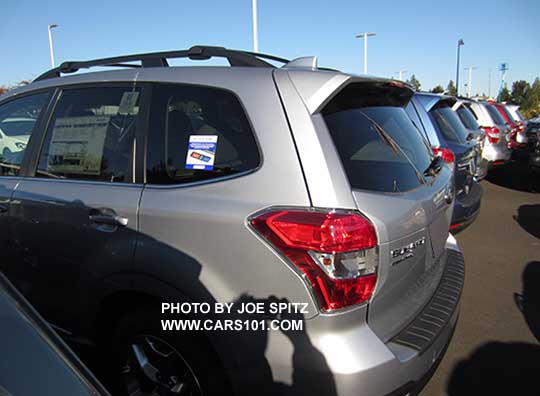 2016 Subaru Forester Limited or Touring with standard rear spoiler and power open/close tailgate. Ice silver shown.