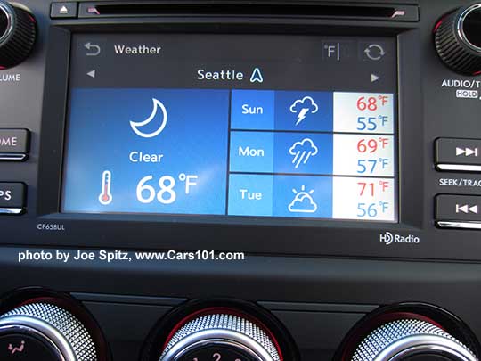 2018 and 2017 Subaru Forester 2.5i base model 6.2" audio screen with physical buttons showing the Starlink app weather screen. Manual heater/AC controls with 4 speed fan