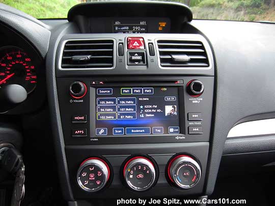 2018 and 2017 Subaru Forester 2.5i base model red lit heater  a/c knobs and 6.2" audio with matte gray surround, shown on the FM radio screen