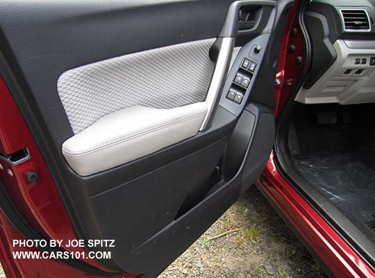 2018 and 2017 Forester front driver's inner door panel with platinum gray cloth door insert and armrest.
