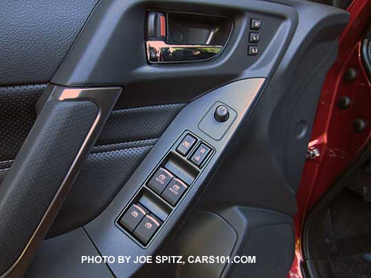 closeup of the 2017 Subaru Forester Touring driver inner door panel with memory driver seat buttons, black perforated leatherette door insert.