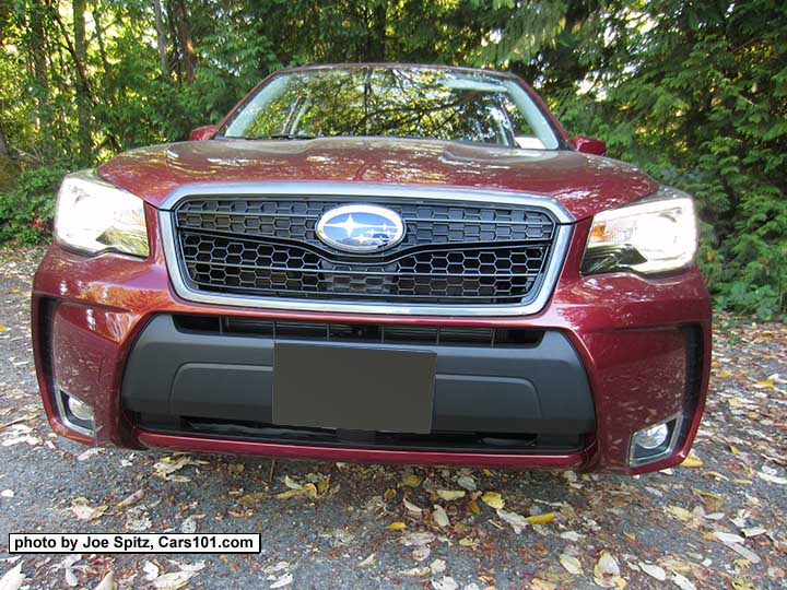 closeup of the  optional 2018 and 2017 Forester Sport Grill with honeycomb center strip and center logo. Shown on a red XT Touring.