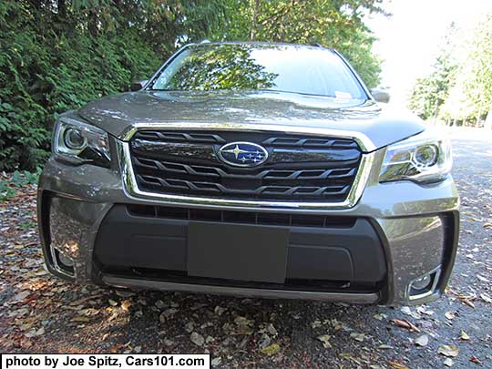 Sepia Bronze 2017 Forester XT model front grill with gloss black center strip and center logo, redesigned for 2017. Touring model shown with fog lights.